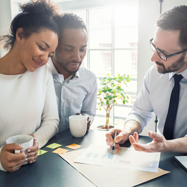 professional going over information with young couple